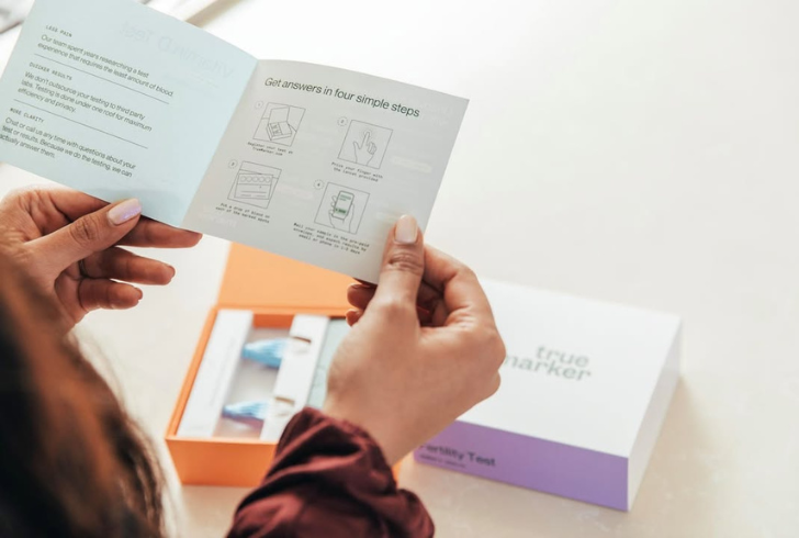 Person reads test kit instructions