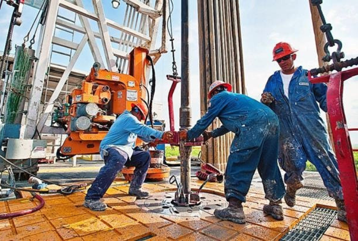 Workers at shale oil drilling site