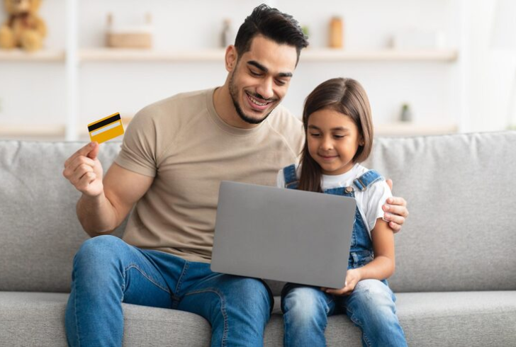 Child using debit card with parent