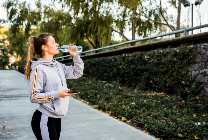 Person drinking water and walking