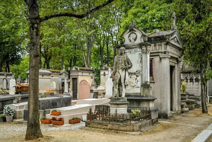 Restored Paris gravestone surrounded by flowers & tress